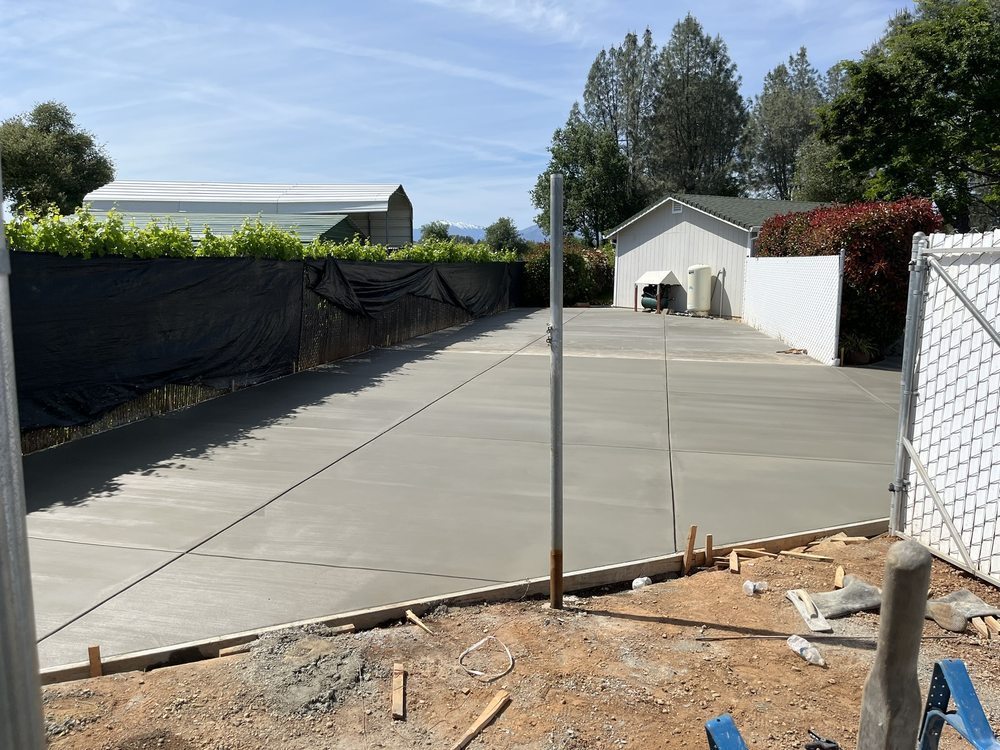 Wide concrete side-yard installation with evenly spaced control joints