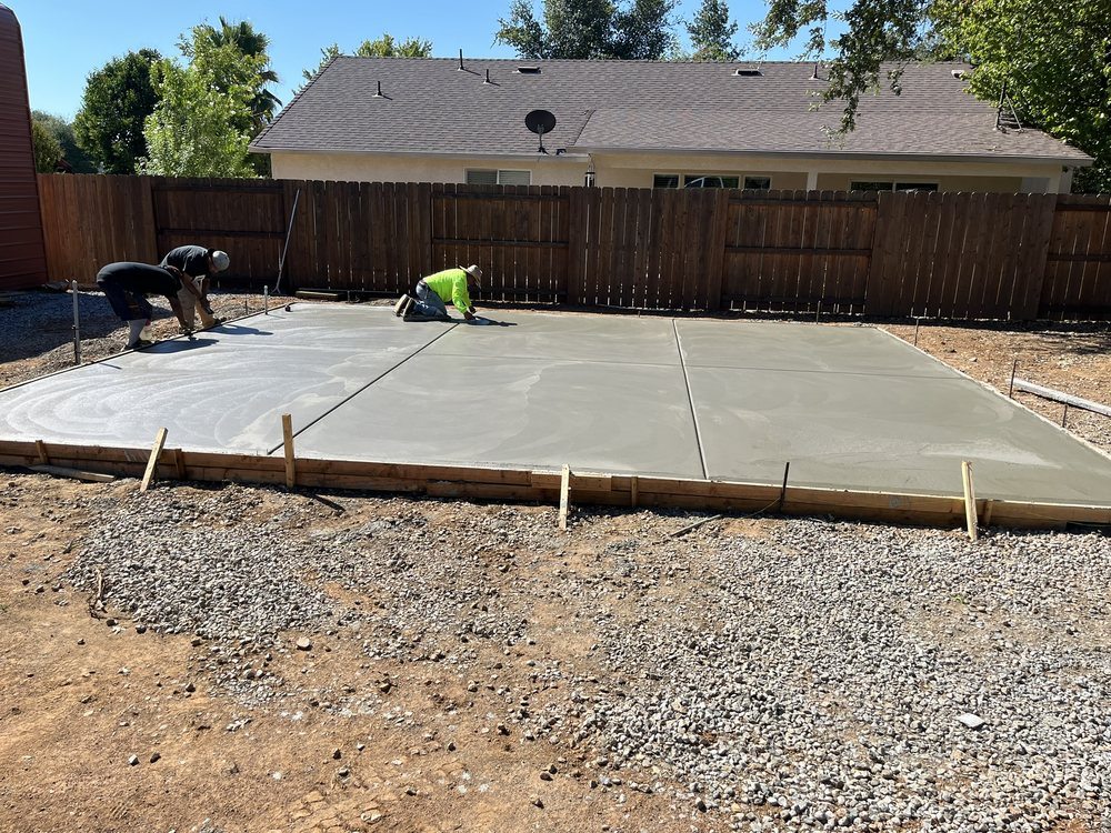 Crew finishing a newly placed concrete slab