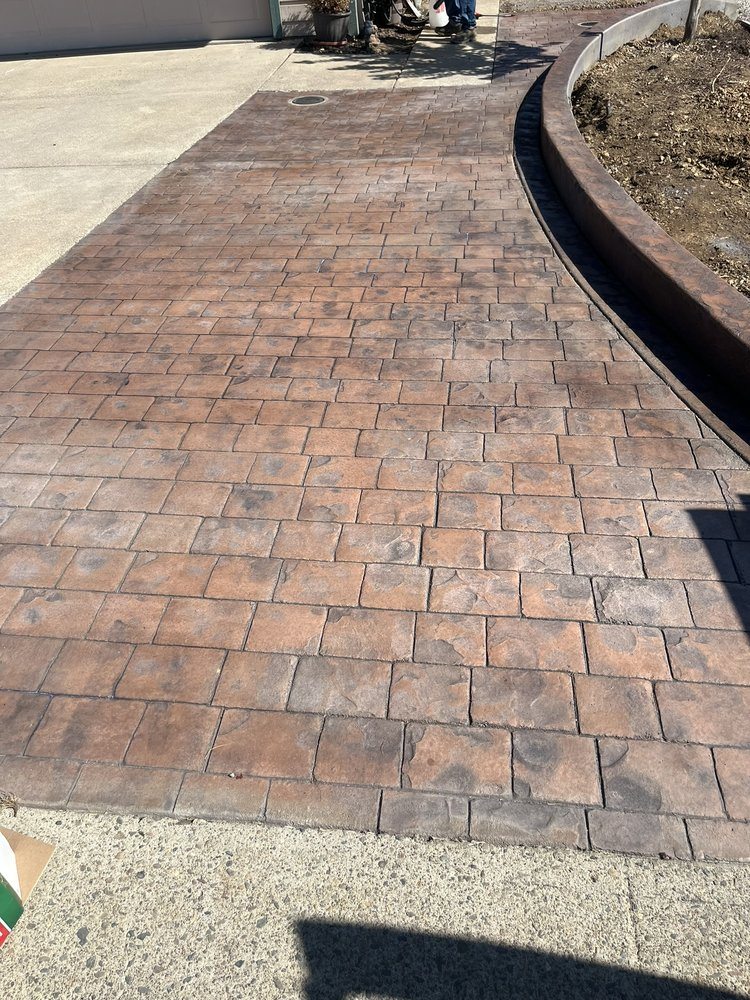 Stamped concrete walkway beside a curved decorative border